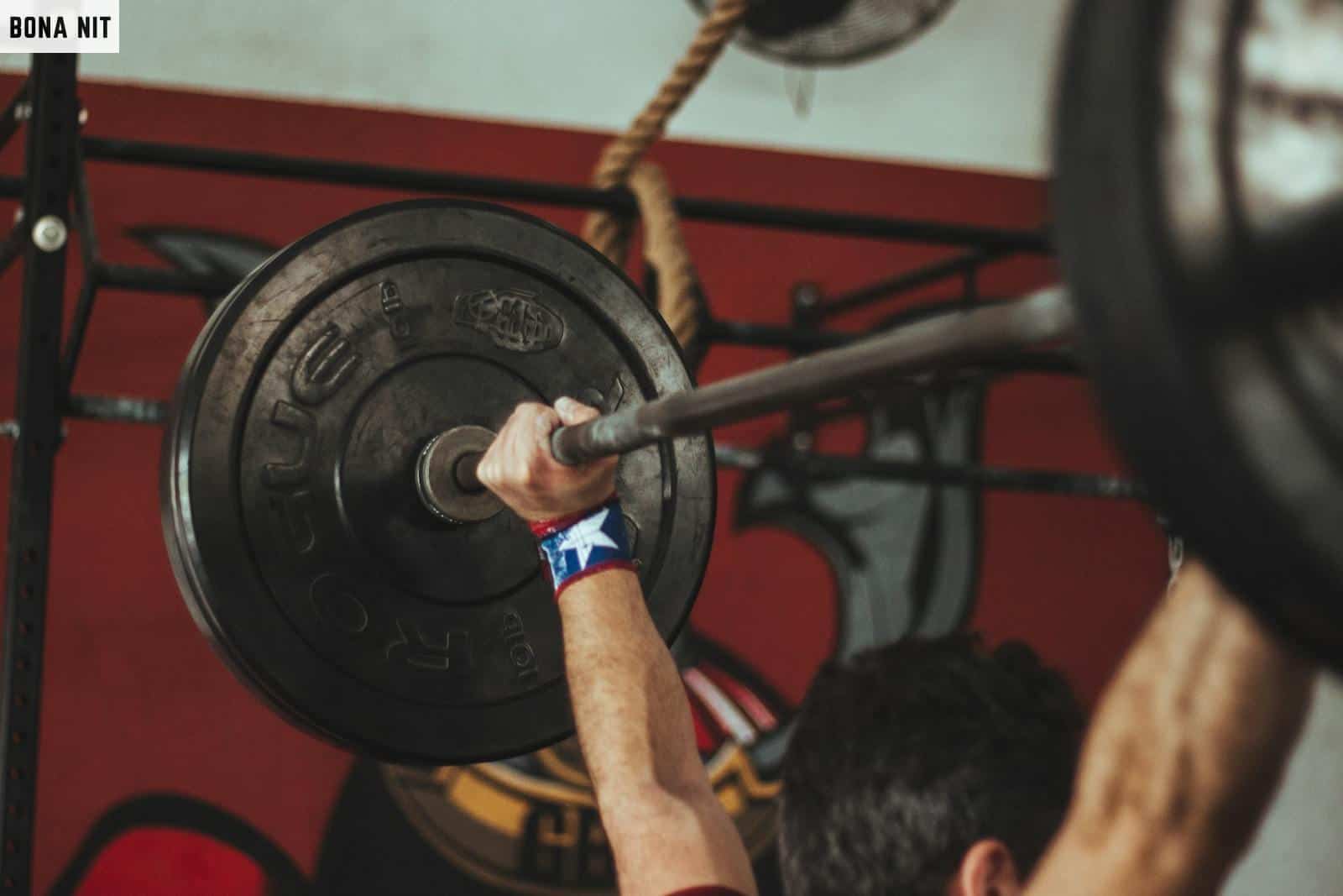 Person Carrying Black Barbell