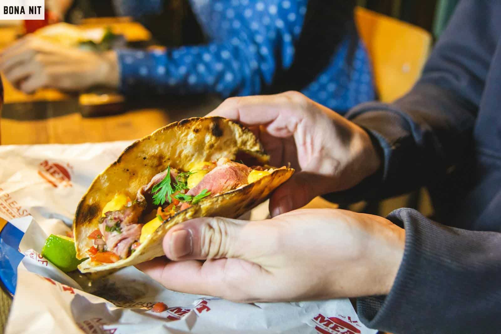 Person Showing Taco With Parsley On Top