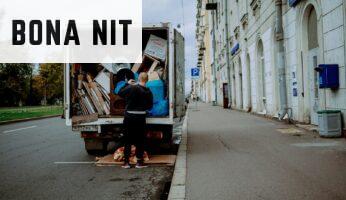 a man unloading furniture from the back of a moving truck